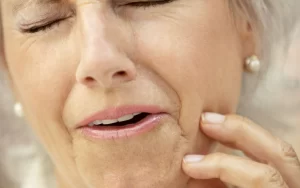 A woman suffering from tooth pain.