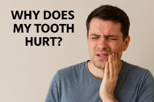 A person seated in a cozy home environment gently touches their cheek with a concerned expression, suggesting tooth pain.